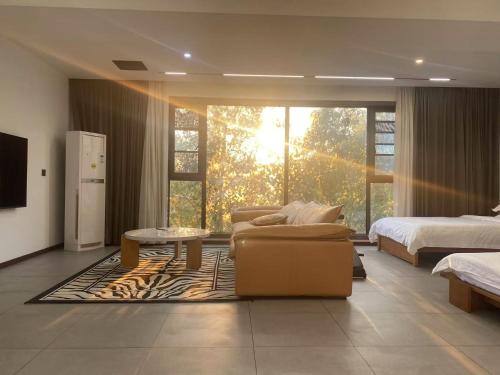a living room with a couch and a bed and a table at 52 Creative Workshop Hotel in Shanshiwang