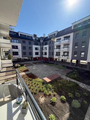 a balcony of a apartment building with a courtyard at Rita Apartman saját parkolóval és erkéllyel in Kecskemét