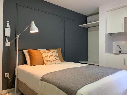 a bedroom with a large bed and a lamp at Casa do Museu in Coimbra