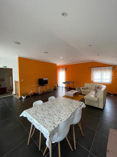 a living room with a table and a couch at Refúgio no Douro - Paz, Conforto e Trilhos in São João da Pesqueira