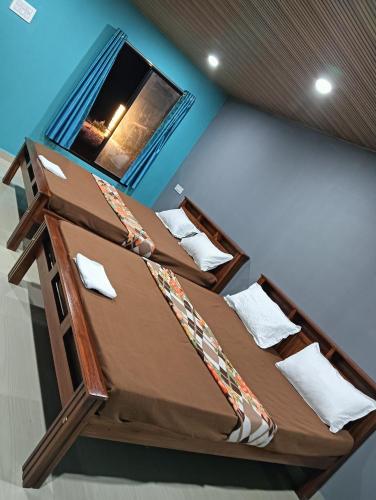 two bunk beds in a room with a window at Lakshika beach resort in Gokarna