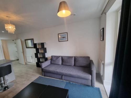 a living room with a couch and a table at Sweet Ivy 1 Bedroom Tottenham in London