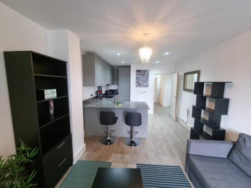 a living room with a couch and a kitchen at Sweet Ivy 1 Bedroom Tottenham in London