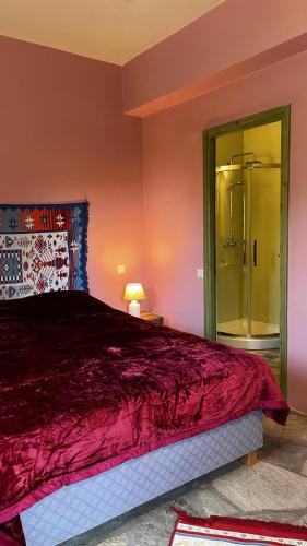 a bedroom with a large bed and a glass shower at ANDRIANA Mountain Home - ASPRIAS 