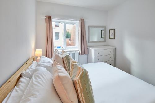a bedroom with a white bed and a window at 94 Roseberry Cottage in the market town of Guisborough in Guisborough