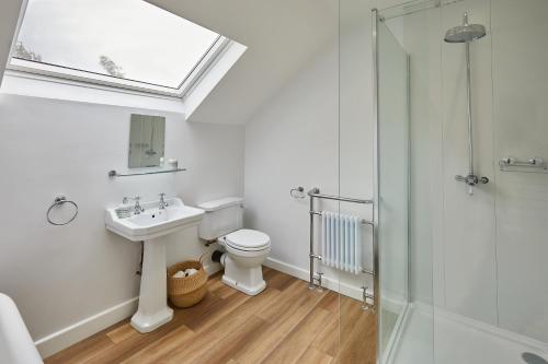 a bathroom with a toilet and a sink and a shower at 94 Roseberry Cottage in the market town of Guisborough in Guisborough