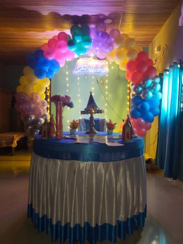 a table with a bunch of balloons on it at Lakshika beach resort in Gokarna