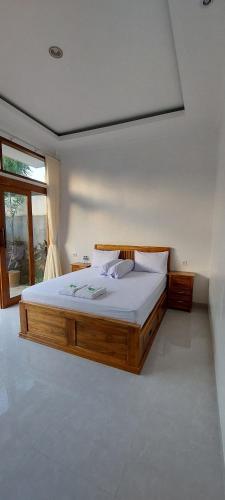a bedroom with a large wooden bed in a room at Villa LOVE INNA, Private, modern with AirCon and Pool in Lovina