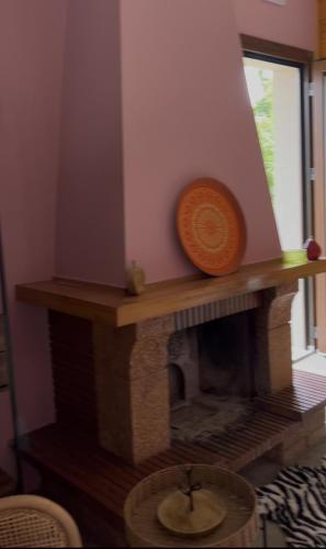 a brick fireplace with a bowl on top of it at ANDRIANA Mountain Home - ASPRIAS 