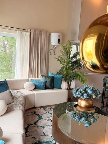 a living room with a couch and a table at Mountain view cottage in Murree