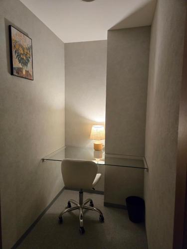 a desk with a chair and a lamp in a room at Kawasaki Central House in Kawasaki