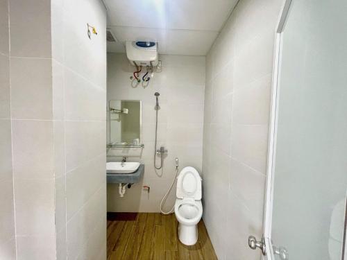 a small bathroom with a toilet and a sink at Hoang Kim Ha Giang Hotel in Ha Giang