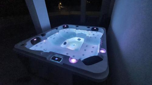 a blue bath tub with lights in a room at Ferienwohnung Adriaperle Villa Casper mit Whirlpool in Palit