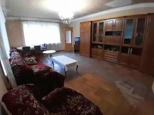 a living room with a couch and a table at Guesthouse in Dsegh Հյուրատուն Դսեղում in Dsegh
