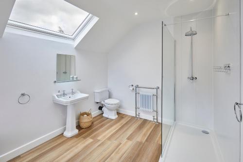 a bathroom with a toilet and a sink and a shower at 96 Roseberry Cottage in the market town of Guisborough in Guisborough