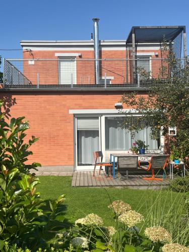 a house with a table and a bench in a yard at Baťovský domek in Zlín