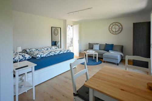 Un dormitorio con una cama y una sala de estar. en Ferienwohnung mit Balkon nahe Interlaken & Adelboden, en Frutigen