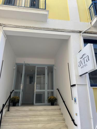 an entrance to an office building with a sign on it at Hotel Avra in Aegina Town