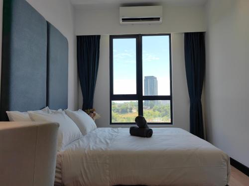 a hotel room with a bed with a stuffed animal on it at Vetro11 Beside QEH1 by JUNE Homestay in Kota Kinabalu