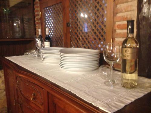 a table with plates and glasses and a bottle of wine at Valderejo Etxea in Lalastra