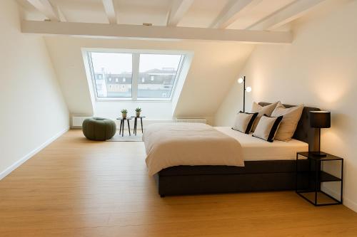 a bedroom with a bed and a large window at Alster Stay no 45 in Hamburg