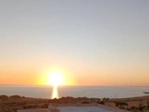 a sunset over the ocean with the sun in the sky at Alykè Appartamenti Vacanze Macari in Macari