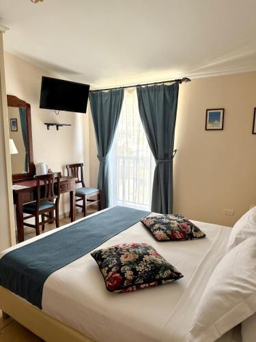 a bedroom with a bed with two pillows on it at Casa Famiani Bed & Breakfast in Letojanni
