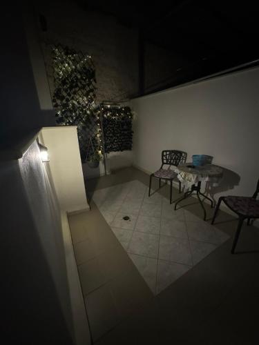 a room with a table and two chairs and a table and a tableearcher at See and City Apartment in Aigio