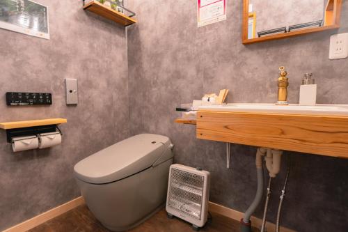 a bathroom with a toilet and a sink at ウッドデザインパーク瀬戸 in Seto