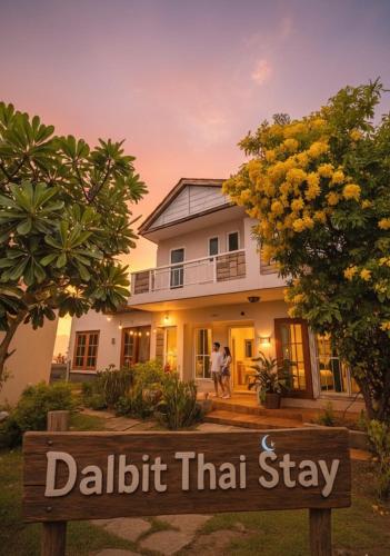 a man standing in front of a house at Dalbit Thai Stay 2 Bedroom Patong house - 8mins walk to Jungcyelon Bangla Rd in Patong Beach