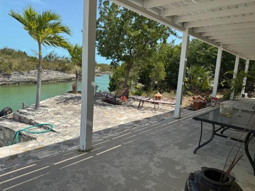 a porch with a view of the beach and water at Waterfront 2-BR Home in Providenciales in Providenciales