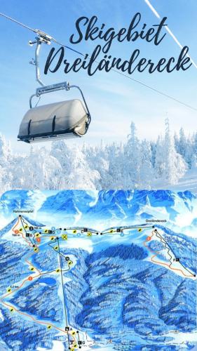 a ski lift with a snowy mountain in the background at Ferienwohnung Storck in Bad Bleiberg