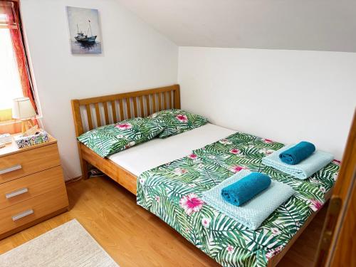 a bedroom with a bed with two pillows on it at Jezero Sniježnica - Vikendica in Sniježnica