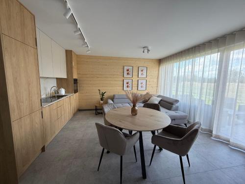 a living room with a table and a couch at Domki Przykona in Zimotki