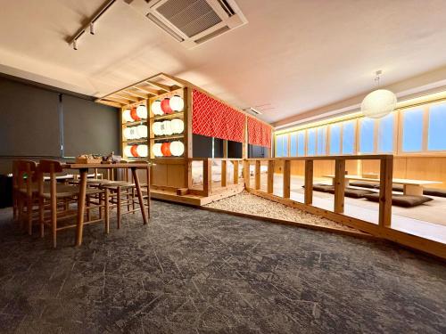 a dining room with a table and chairs at OMATSURI BASE Nakanoshimbashi in Tokyo