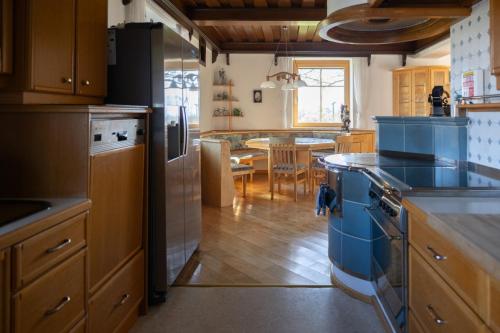 a kitchen with a stove and a dining room at Zum Stroama in Wies