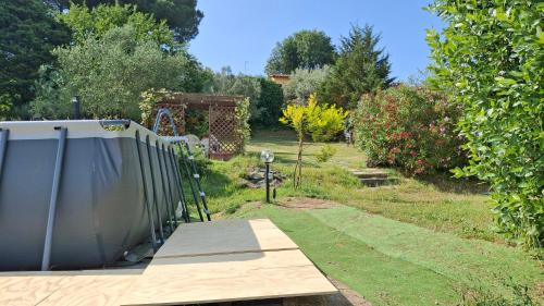 a wooden bridge over a garden with trees at Casa Gelso in Scandicci