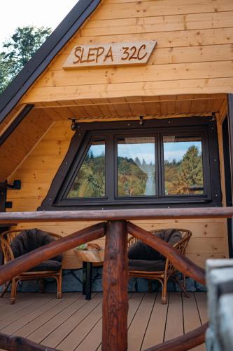 a log cabin with windows on the roof at Domek za Księżycem - azyl z balią, kominkiem i prywatnym ogrodem, Ustroń in Ustroń