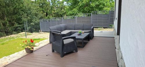 a patio with a table and chairs on a deck at ARAMIKA apartamenty in Szklarska Poręba