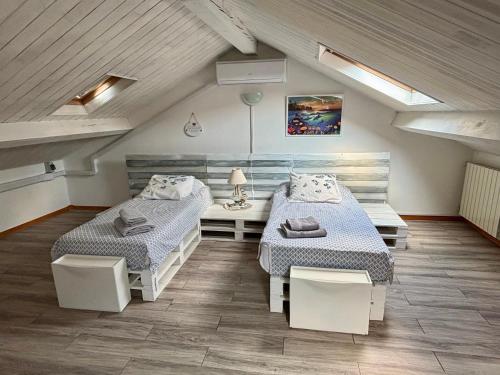 a room with two beds in a attic at Brezza Marina in Diano Marina