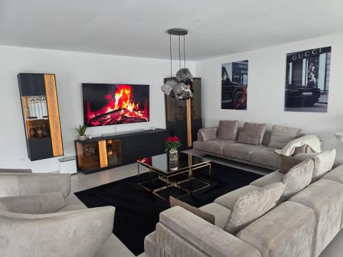 sala de estar con sofá y chimenea en la TV en Die Stadtvilla, en Holzminden