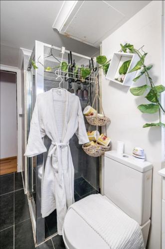 a bathroom with a toilet and some plants in it at Ultimate Beach Pad in Sydney