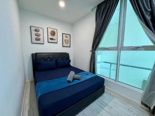 a bedroom with a blue bed with a large window at SA Sutera Avenue Homestay Kota Kinabalu Area KK City Opposite Imago in Kota Kinabalu