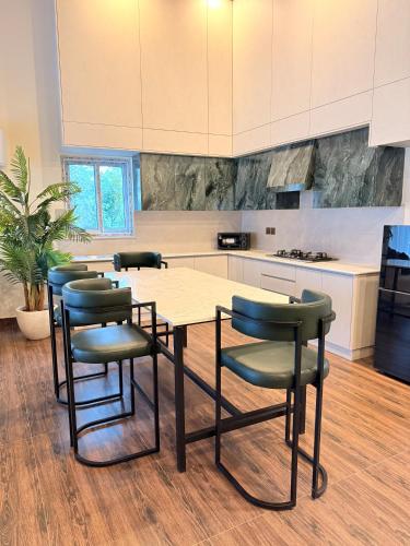 a kitchen with a table and chairs in a room at Mountain view cottage in Murree