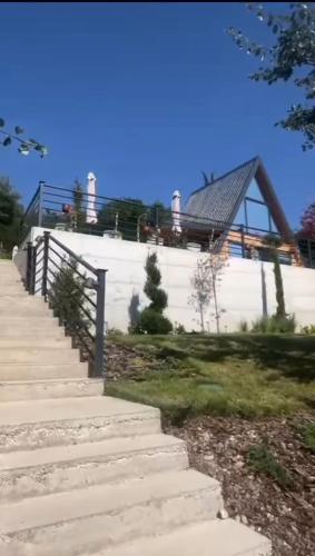 a staircase leading up to a house with a roof at Panorama Pool Hills in Ledinci