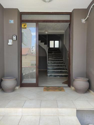 a bathroom with two toilets and a hallway with stairs at Flat30 - Cosy apartment in Park of Kipseli- Xanthi in Xanthi