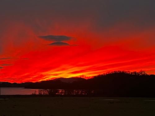 a sunset with a red sky and clouds at Melfort House in Kilmelfort