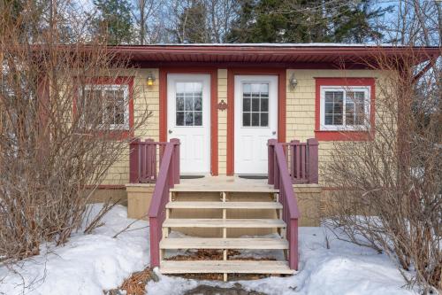 a tiny house in the snow with a staircase at Dominion Hill Country Inn in Bocabec