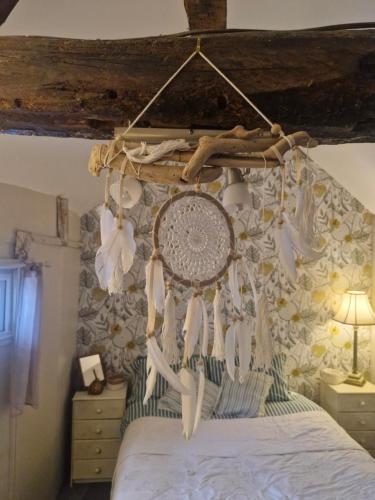 a bedroom with a canopy bed with a flower wall at charming rustic stable conversion 