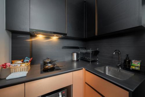 a kitchen with a sink and a counter top at Vacaystation Edge Central Pattaya in Pattaya Central